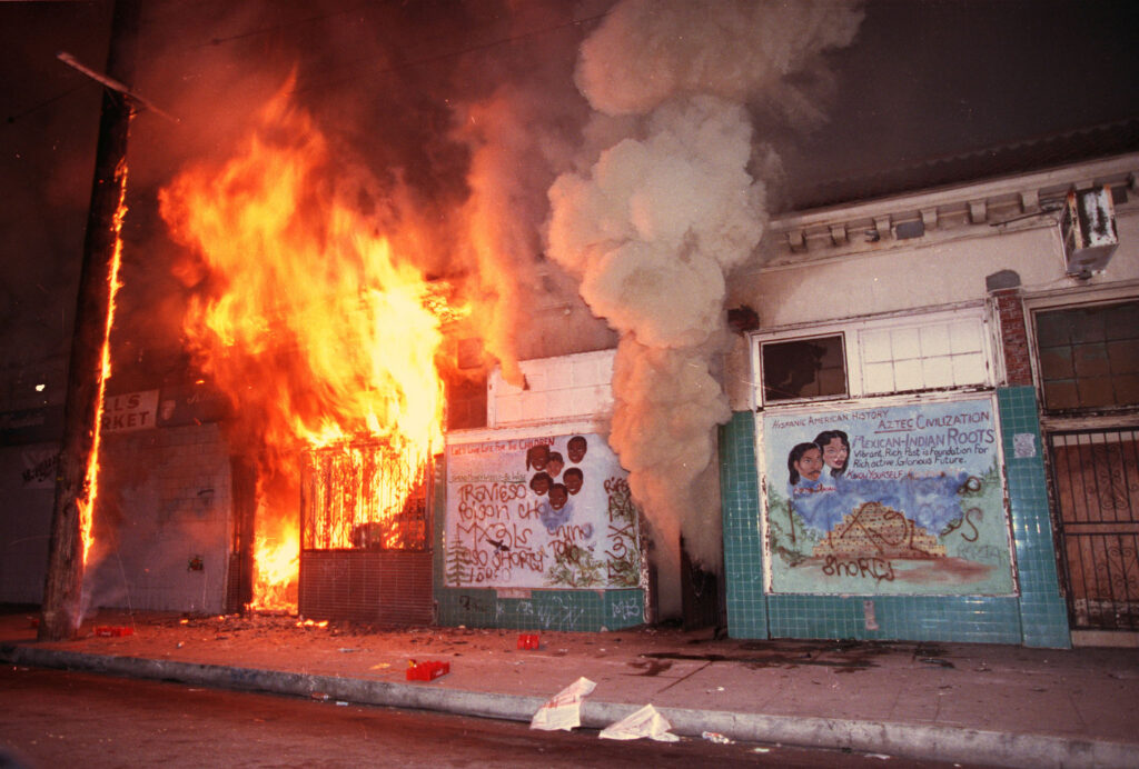 A business is set ablaze at the start of the 1992 Los Angeles Riots